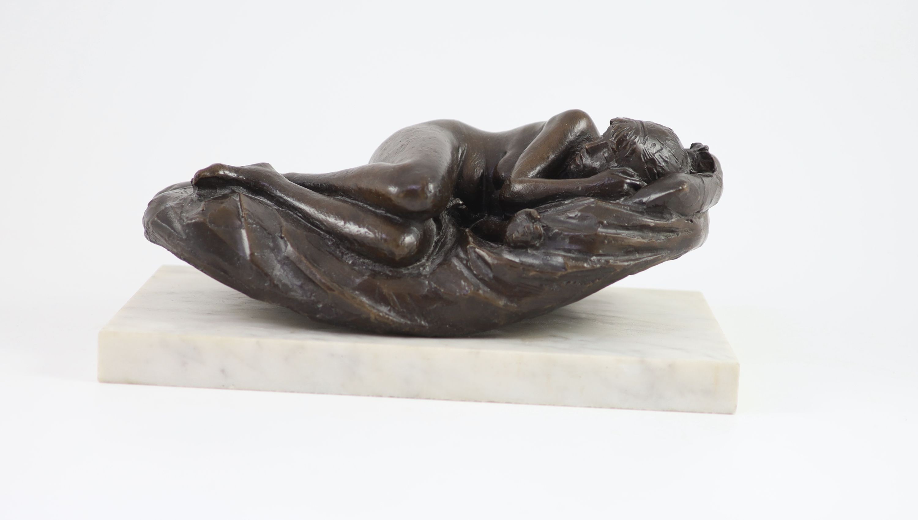 James W. Butler. RA., A bronze model of a sleeping girl, width 31cm depth 18cm height 13cm